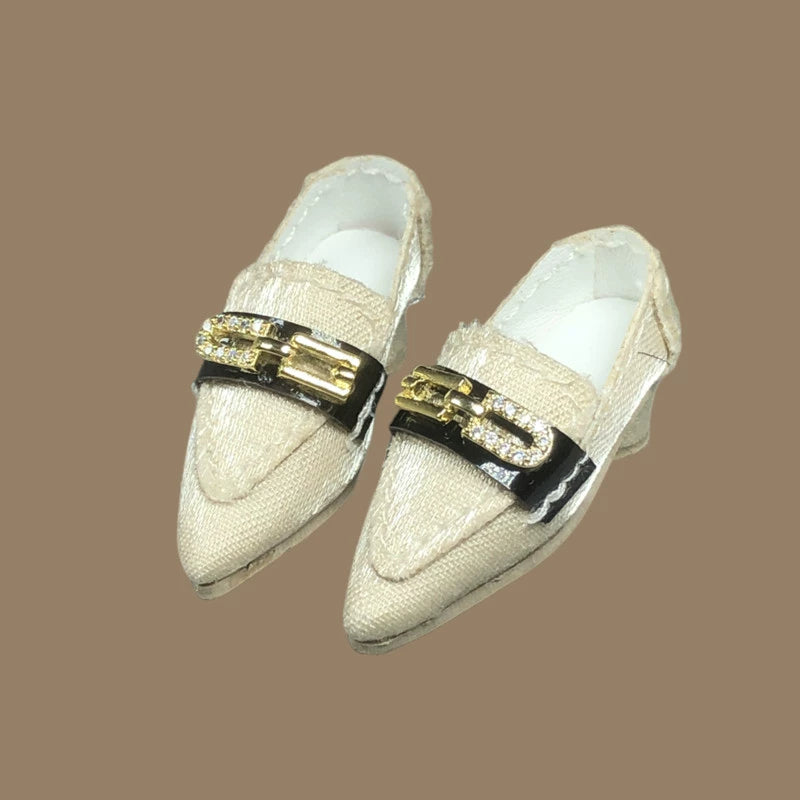White low-heel doll pumps with metal chain detail and glossy nylon finish