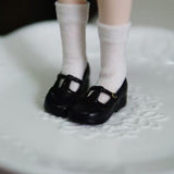 Black 1/6 scale vintage T-strap Mary Jane doll shoes with patent-look finish
