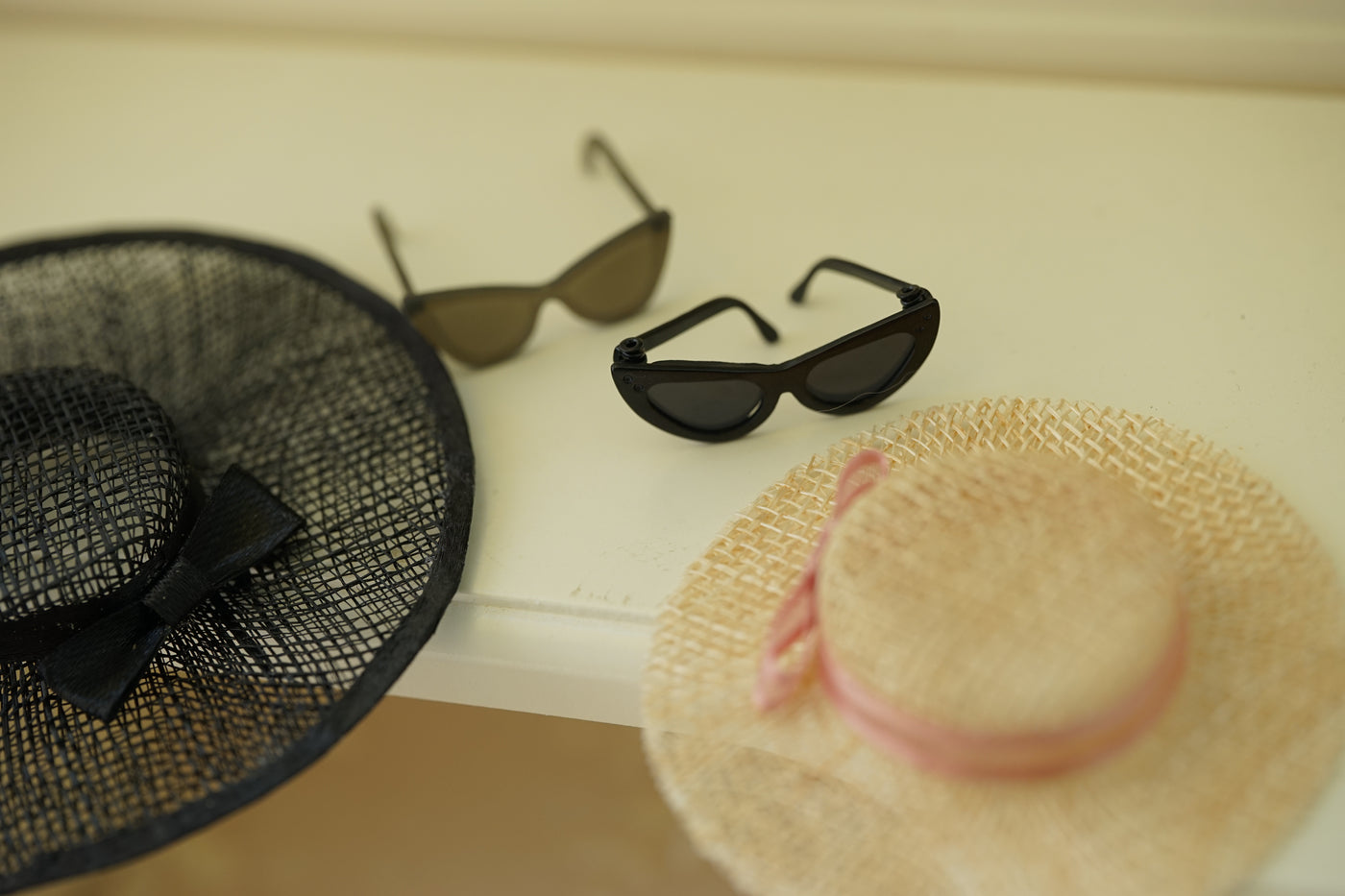 Close-up of a vintage-inspired miniature straw hat for collectible fashion doll