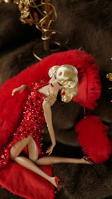 Fashion doll in a red evening dress styled with a red faux fur stole