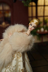Fashion doll wearing a pale faux fur stole over a sequined evening gown