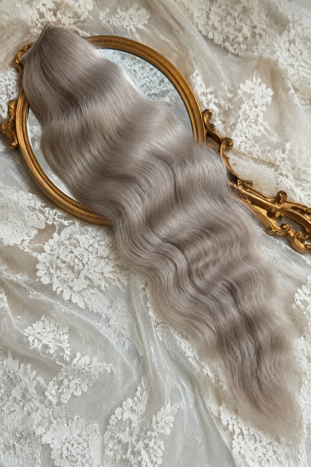 Ash blonde natural mohair doll hair, three-quarter view on ivory lace with a gold baroque mirror