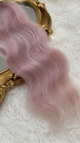 Dusty pink natural mohair doll hair, three-quarter view on ivory lace with a gold baroque mirror