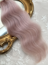 Close-up of dusty pink natural mohair doll hair showing fine fibers, waves and silky sheen