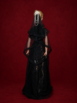 Back view of black gothic lace doll wedding gown with veil on deep burgundy background