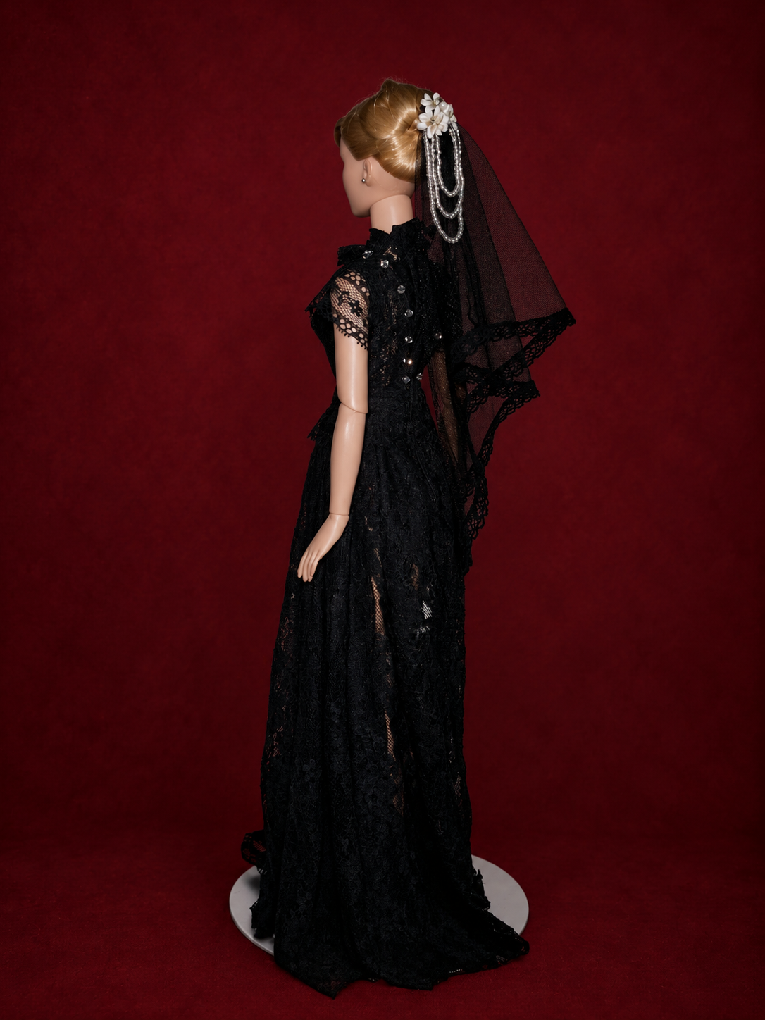 Side view gothic doll lace wedding dress and veil with burgundy textured studio background