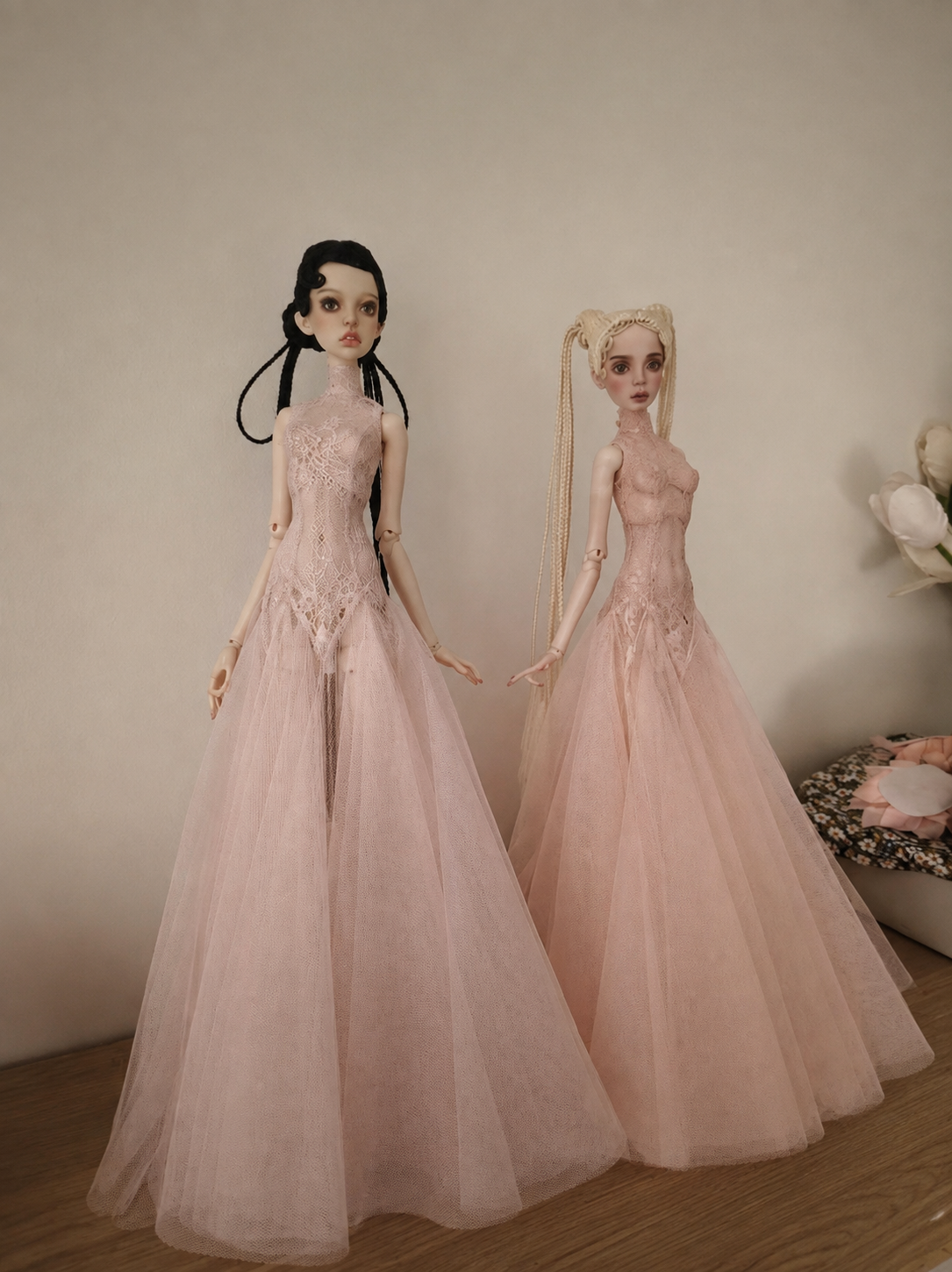 Black long doll gown with a close-fitting shape and flared lower silhouette.