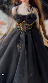 Dark romantic styling image of a sheer black long dress for a fashion doll.